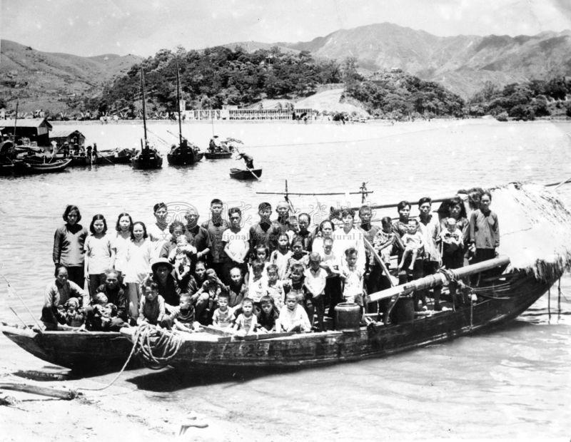 Fisherman Su Jiudai and three generations of his family, forty-eight people in total, arriving on the shores of Hong Kong after escaping overnight from Huiyang, Guangdong on four wooden sampans during the Great Famine.